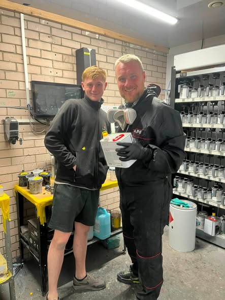 Members of the Spartan Auto Repair team in the paint mixing room